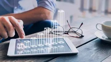 Customer-Success-Management bedeutet auch, die Zahlen im Blick zu behalten. Gezeigt wird ein Tablet mit einem Balkendiagramm. R&P unterstütz Sie gerne.