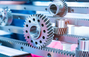 Metal cog gears on blue background